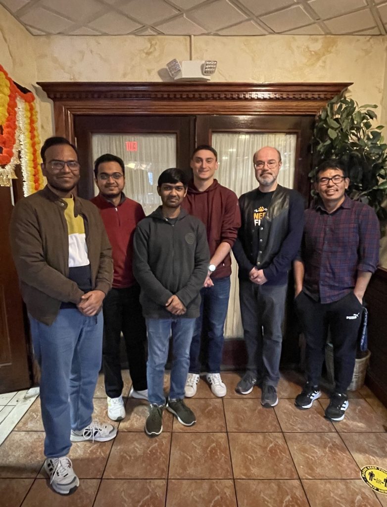 CMCD group members standing in front of an entrance of an Indian restaurant